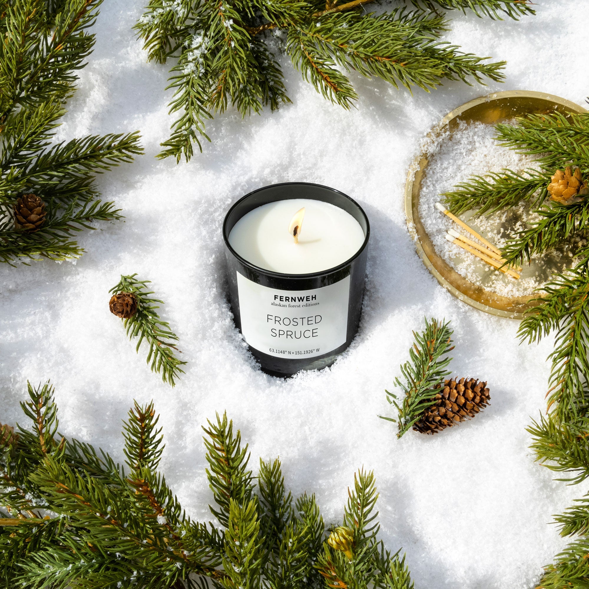 Frosted Spruce soy candle in snowy Alaskan forest scene